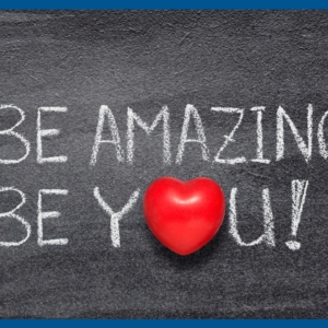 Statement Be Amazing Be You written on a chalkboard with a red heart or the O in You