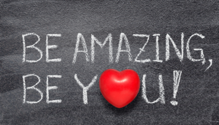 Statement Be Amazing Be You written on a chalkboard with a red heart or the O in You