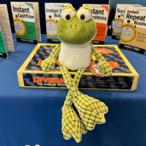 Cuddly Frog Toy with Instant Cashflow and Instant System books in the background
